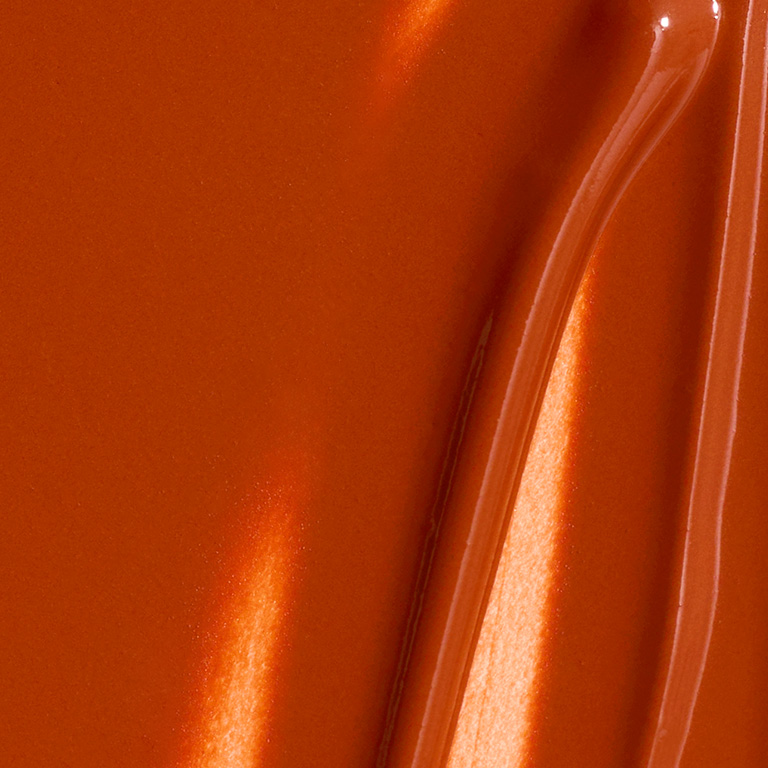 A woman's hand with drops of skin care products on it.